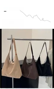 Close-up of hobo shoulder bags in beige, coffee, and black with soft matte finish