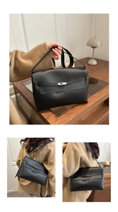 Detail view of a black grain leather tote bag with classic silver clasp and shoulder strap