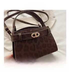 Macro view of leopard print texture and gold CD metal buckle on crossbody bag