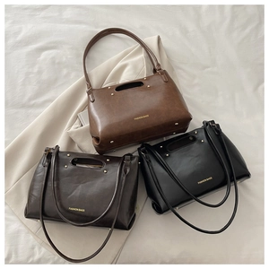 Three vintage tote bags in black, coffee, and brown colors with golden hardware