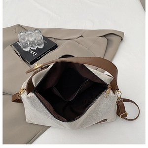 Detail view of the canvas bag interior featuring a functional zipper pocket and lining