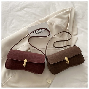 Detail of leopard print suede underarm bags with golden metallic locks in chic autumn colors