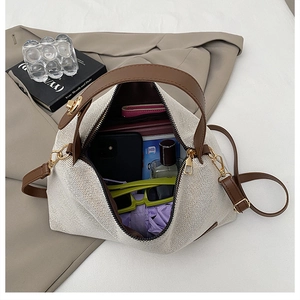Detailed interior view of a beige canvas tote bag showing large storage capacity for items