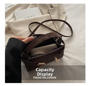 Top view of dark brown crossbody bag interior showing phone and cosmetic storage space