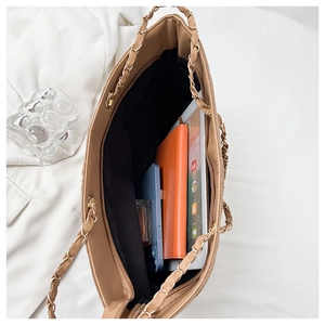 Top-down view of a khaki tote bag interior showing its large capacity for a tablet and phone