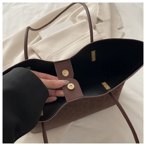 Close-up of leopard print tote bag showing internal magnetic closure and spacious interior