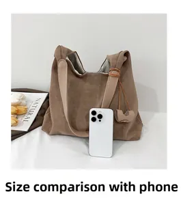 Brown textured tote bag size comparison with a smartphone showing large capacity