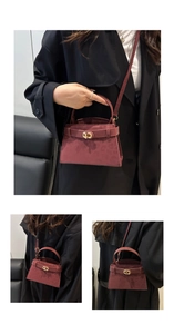 Macro detail of the leopard print suede fabric and golden twist lock on the burgundy handbag