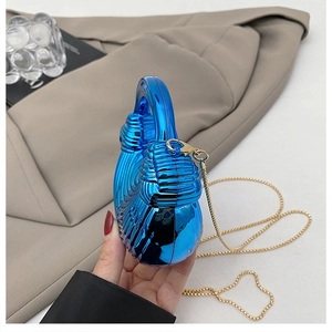 Detail of blue electroplated mirror mini bag with spiral wave texture and gold chain