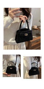 Detail of black leopard embossed crossbody bag with golden CD buckle and top handle