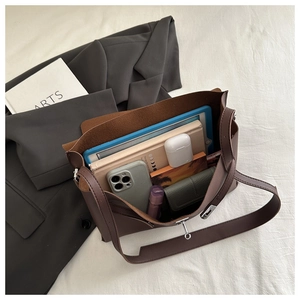 Top view of deep brown tote bag showing spacious interior with tablet and daily essentials