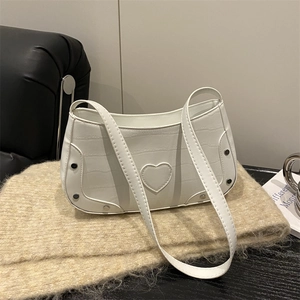 White faux crocodile leather crescent bag with heart patch and silver rivets