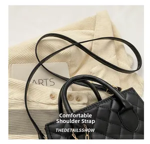 Detail of comfortable shoulder strap and black quilted leather texture on bag