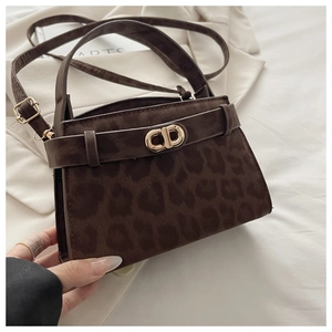 Detailed close-up of brown leopard print handbag featuring a gold CD letter buckle