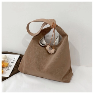 Close-up of taupe tote bag with rustic texture and minimalist decorative knot detail
