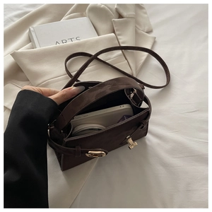 Interior view of brown suede mini crossbody bag showing storage space for phone and makeup