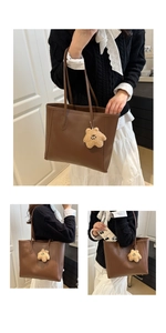 Detail view of large brown tote bag with star plush charm showing spacious interior space