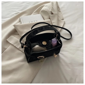 Interior view of black velvet handbag showing capacity for cosmetics and a wallet