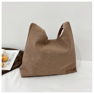 Detailed texture of brown retro tote bag with minimalist design in a lifestyle setting