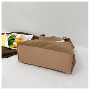 Detail shot of vintage brown shoulder bag showing white stitching and leather texture