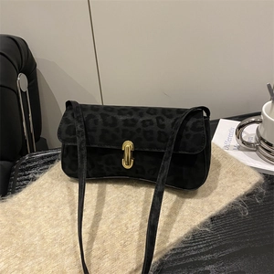 Chic black leopard print underarm bag with gold oval buckle on a knit background