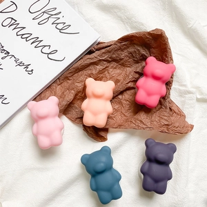 Detail of matte bear-shaped phone grips in five assorted pastel and purple colors