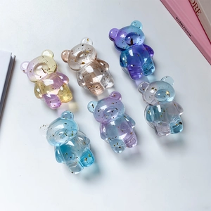 Detail of transparent bear phone grips with gold foil flakes in various gradient colors