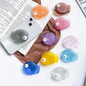 Macro shot of colorful 3D fish phone grips showing textured scales and matte finish