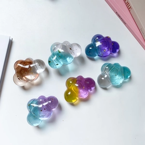 Detail of transparent cloud phone grips with colorful gradients and gold foil flakes