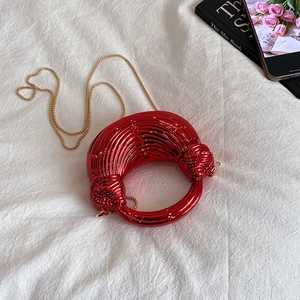 Chic red acrylic moon-shaped shoulder bag with metallic rings and gold chain strap