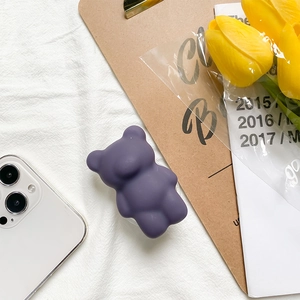 Detail shot of purple bear phone socket stand on a lifestyle aesthetic background