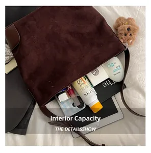 Detailed interior of a large brown suede tote bag showing its spacious capacity