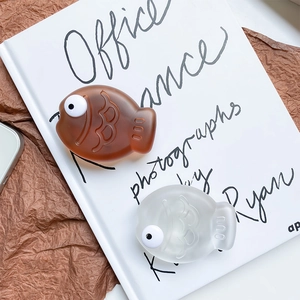 Detailed view of creative fish-shaped phone grip with realistic scale texture and 3D eyes