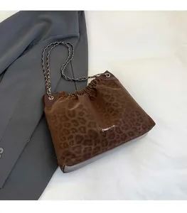Detail of leopard print tote bag featuring soft faux fur fabric and chain strap