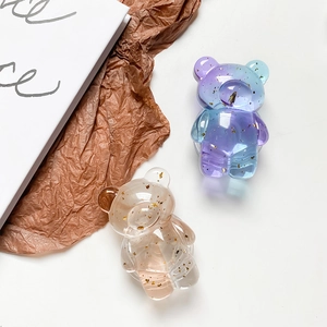 Detail view of bear phone grips with gold foil inlay and gradient resin texture