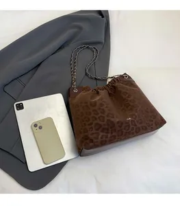 Detail of leopard print tote bag with silver chain strap and Creative Cat logo