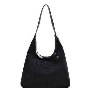 Minimalist black suede hobo shoulder bag with contrast stitching and leather side knot