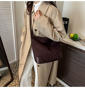 Detail of dark brown tote bag showing durable leather corners and premium suede texture