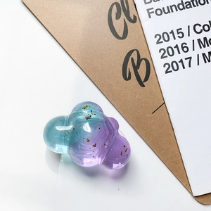 Detailed view of cloud-shaped phone socket with blue-purple gradient and gold foil