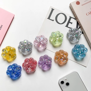Macro shot of 10 colorful cat paw phone grips with glitter resin and translucent finish