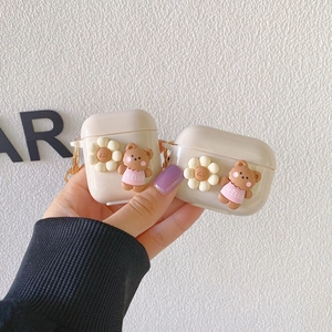 Cute silicone AirPods Pro case with 3D sunflower and bear doll held in hand