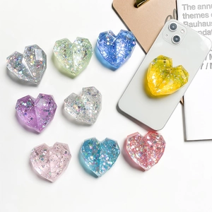 Close-up of assorted colorful glittery heart-shaped epoxy resin phone socket accessories