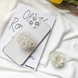 Detailed view of elegant white pearl and cream 3D rose flower phone grip holders