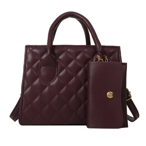 Burgundy quilted handbag set with gold hardware and matching coin purse on white background