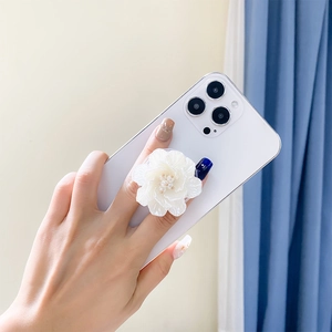 Detail of 3D pearl rose flower phone grip being held to show texture and size