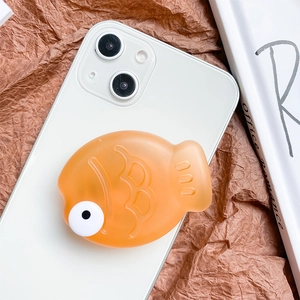 Close-up of cute 3D orange fish-shaped expandable phone grip on a white smartphone