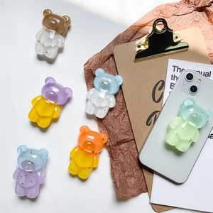 Collage of six colorful resin bear pop sockets with gold foil glitter for phone grip