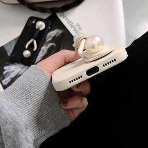 Close-up of matte silicone phone case featuring luxury large pearl wrist strap decoration