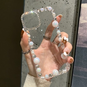 Close-up of clear iPhone case featuring large luxury pearls and sparkling rhinestones