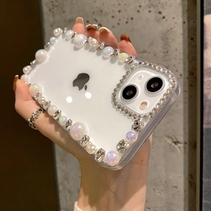 Detailed view of clear iPhone case featuring handmade pearls and sparkling rhinestones